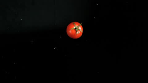 Fresh Tomato Spinning in Elegant Slow Motion on Black Background