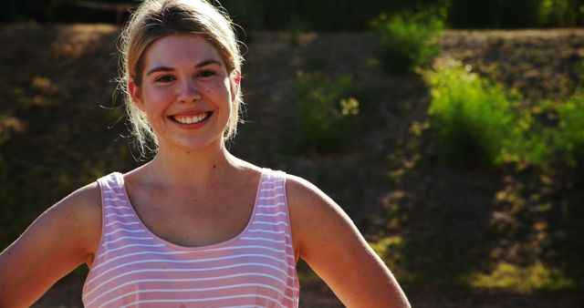 Smiling Woman in Pink Striped Tank Top Enjoying Sunny Outdoors - Download Free Stock Images Pikwizard.com