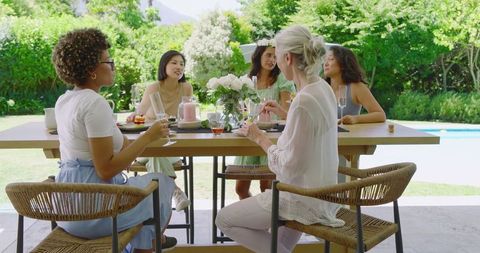 Women Celebrating Friendship with Brunch by Poolside