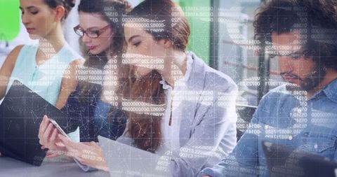 Young Professionals Engaged in Collaborative Data Analysis