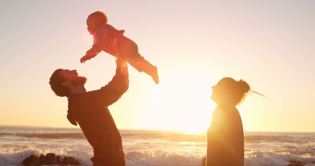 Joyful Family Bonding at Beach During Sunset - Download Free Stock Images Pikwizard.com