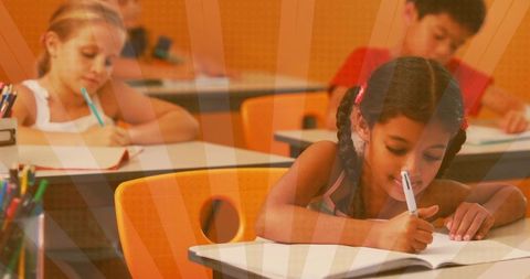 Elementary Girl Writing at School Desk with Braids and Bright Orange Chairs