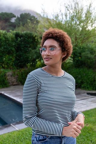 African American Woman Relaxing Near Pool in Backyard Setting