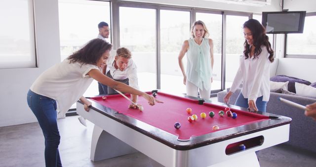 Diverse business colleagues bond over a game of pool in a bustling creative office. - Download Free Stock Photos Pikwizard.com
