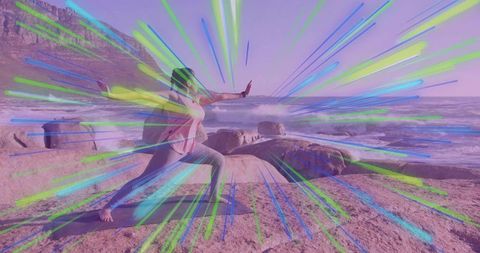 Woman practicing yoga on rocky coast with vibrant energy burst