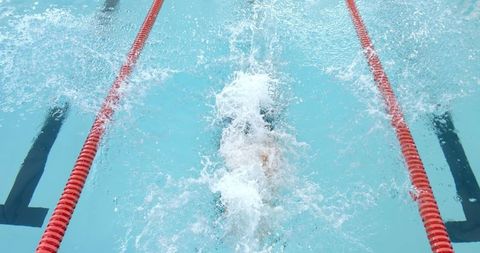 Swimmer Competing in Pool with Energetic Splash - Download Free Stock Images Pikwizard.com