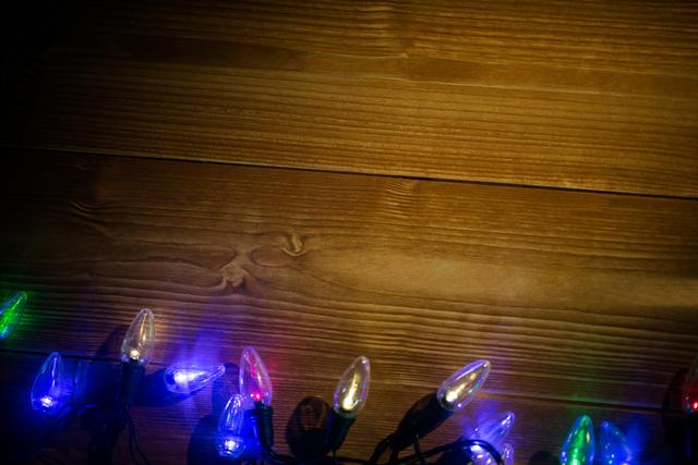 Rice lights illuminated on wooden plank during christmas time