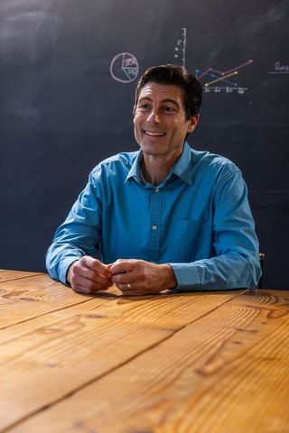 Confident male lecturer presenting data in classroom