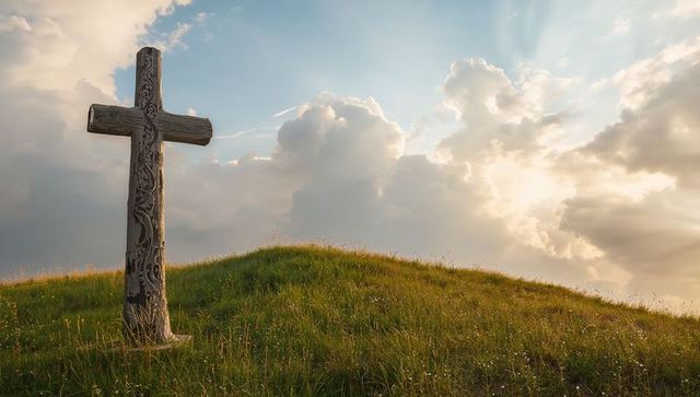 Ornate wooden cross in peaceful hilltop meadow