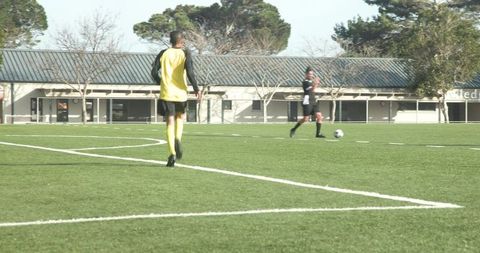 Soccer players practicing passes on sunny day