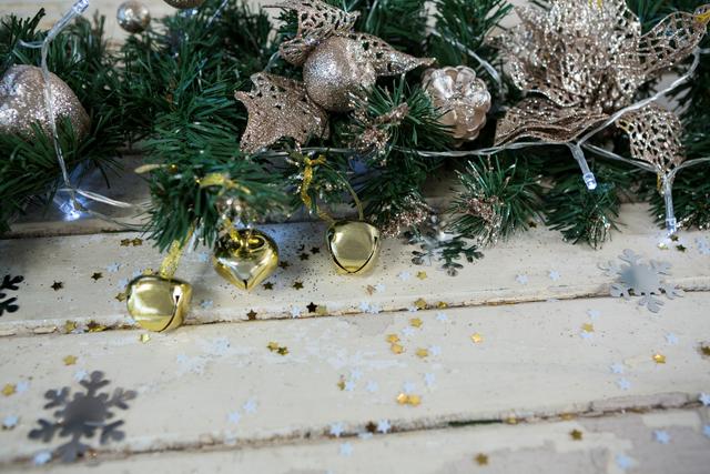 Perfect for holiday-themed projects, this image showcases festive Christmas tree decorations with gold bells, glittery ornaments, and a garland. Ideal for use in holiday cards, festive advertisements, seasonal blog posts, and Christmas event promotions.
