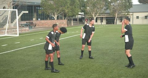 Soccer Players Enjoying Friendly Interaction During Practice