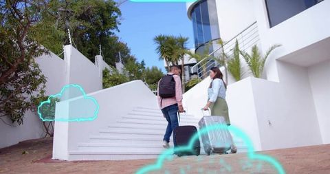 Travel companions walking up white staircase pulling rolling suitcases with cyan overlays