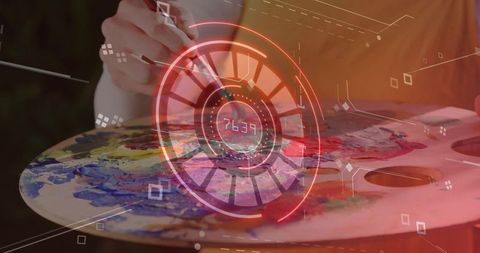 Artist mixing colorful paint on wooden palette with futuristic hud overlay, numeric readout
