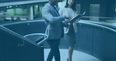 Professional collaboration in corporate office lobby with modern architecture