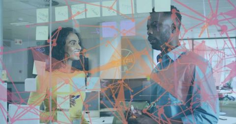 Coworkers Brainstorming Behind Glass in Modern Office with Network Graphic