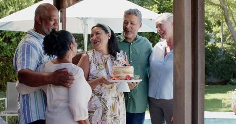 Diverse Senior Friends Celebrating Birthday in Sunny Backyard Party