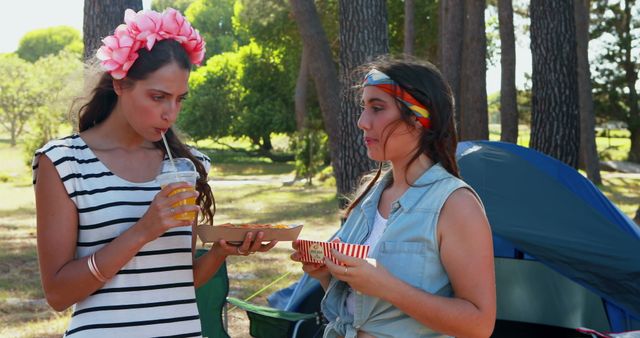 Young Women Enjoying Food and Drinks During Camping Trip in Forest - Download Free Stock Images Pikwizard.com