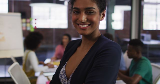 Confident Businesswoman Smiling In Office Setting - Download Free Stock Images Pikwizard.com