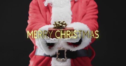 Santa claus holding gift with merry christmas text overlay