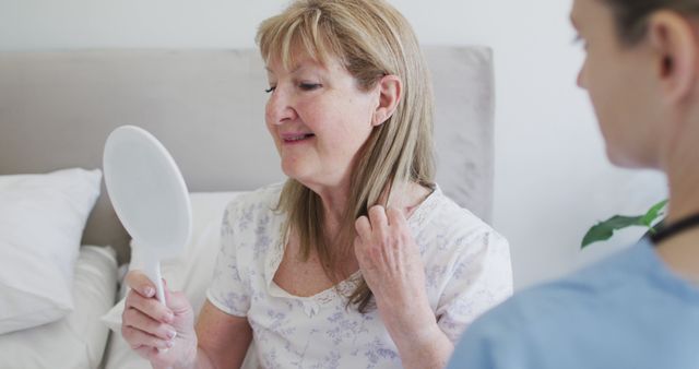 Senior Woman Smiling in Mirror with Caregiver Assistance - Download Free Stock Images Pikwizard.com