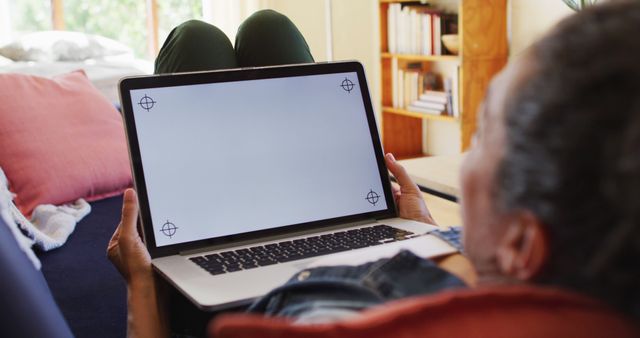 Person Lying on Sofa Using Laptop with Blank Screen at Home - Download Free Stock Images Pikwizard.com