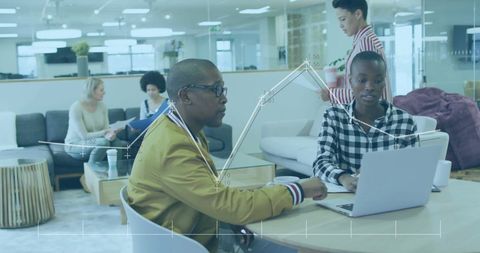 Diverse Professionals Analyzing Data in Modern Office Space