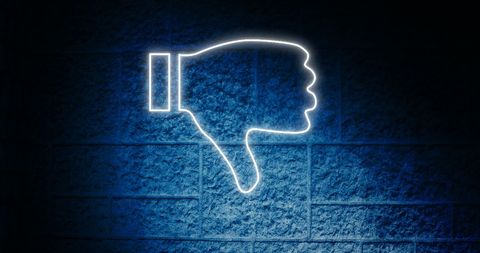 Glowing thumbs down icon against dark blue background