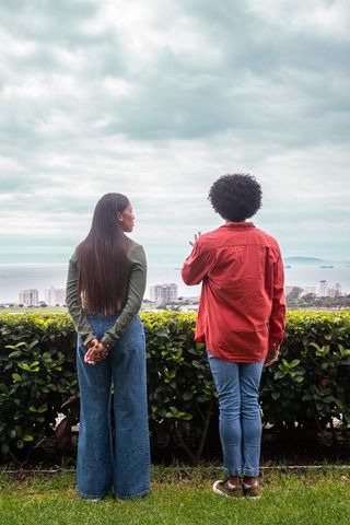 Diverse friends enjoying scenic urban view from terrace
