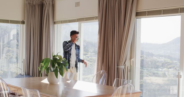 Young Man Drinking Coffee in Bright Modern Dining Room - Download Free Stock Images Pikwizard.com