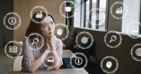 Asian Businesswoman Surrounded by Digital Network Icons in Office