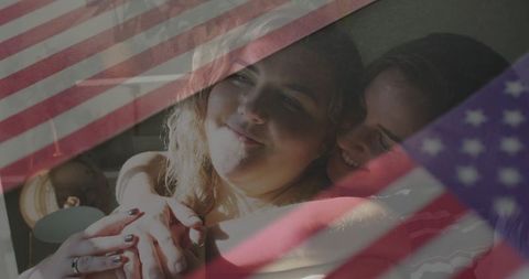 Romantic couple embracing with american flag overlay, cozy intimacy