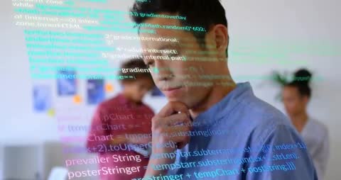 Male Programmer Working on-Code in Tech Office With Colleagues