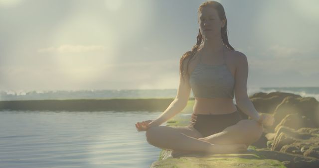 Woman Meditating in Lotus Position by Ocean at Sunrise - Download Free Stock Images Pikwizard.com