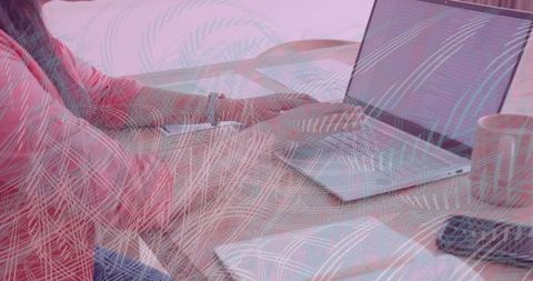 Young professional typing on laptop collaborating remotely