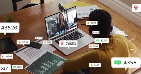 Remote collaboration reviewing live charts and analytics on laptop in home workspace