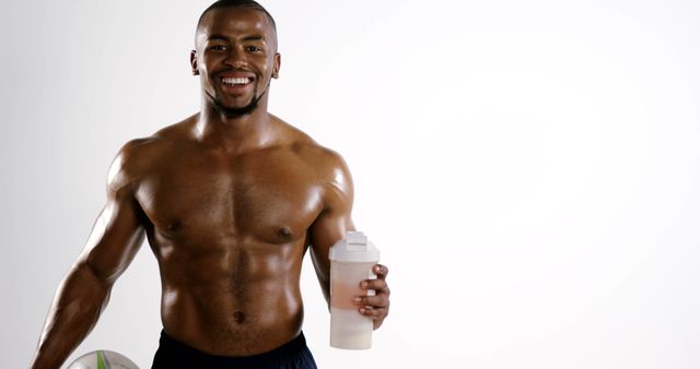 Athletic Man Holding Protein Shake and Smiling Confidently - Download Free Stock Images Pikwizard.com