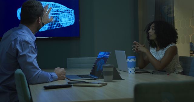 Engineers Discussing Car Design in Modern Office at Night - Download Free Stock Images Pikwizard.com