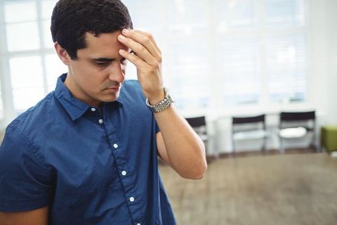 Pensive Business Professional Reflecting in Modern Office