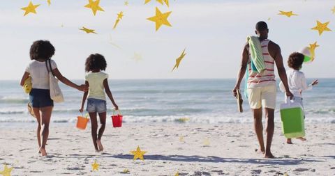 Returning family enjoying fun day at beach