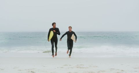 Two Male Surfers Running Towards Ocean with Surfboards - Download Free Stock Images Pikwizard.com