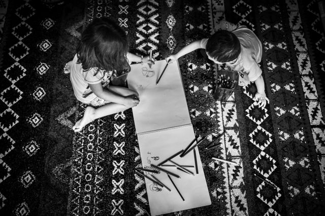 Children Drawing Together on Patterned Carpet - Download Free Stock Photos Pikwizard.com