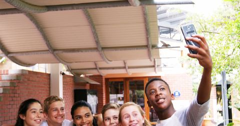 Diverse Teens Smiling for Selfie Outdoors, Friendship and Joy