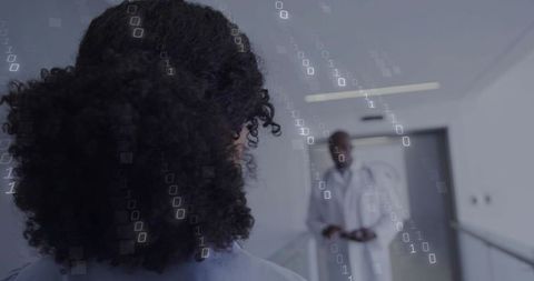 Curly-haired nurse facing doctor in medical corridor with digital binary data overlay
