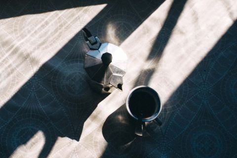 Moka Pot with Coffee Cup on Sunlit Table