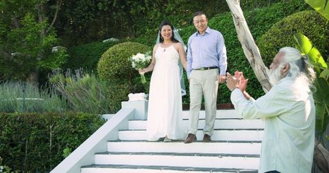 Senior Bride and Groom Celebrating Wedding with Friends in Sunny Garden