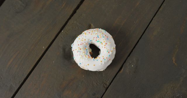 Glazed Donut with Colorful Sprinkles on Wooden Table - Download Free Stock Images Pikwizard.com