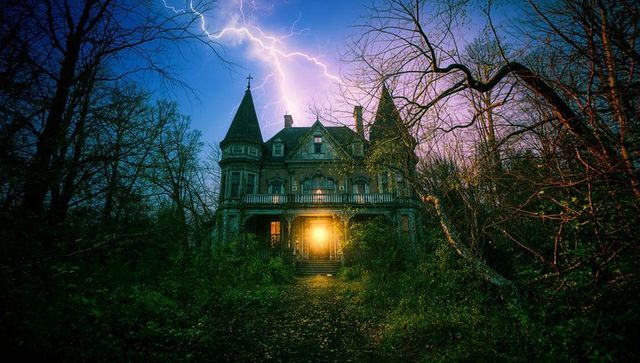 Gothic victorian mansion at night in lightning storm