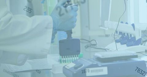 Scientist handling laboratory equipment with statistical overlay for covid-19 research