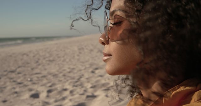 Relaxed Woman with Curly Hair Enjoying Sunset on Beach - Download Free Stock Images Pikwizard.com